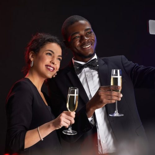 waist-up-portrait-elegant-mixed-race-couple-taking-selfie-photo-while-standing-against-black-background-party-copy-space_236854-27183 (1)